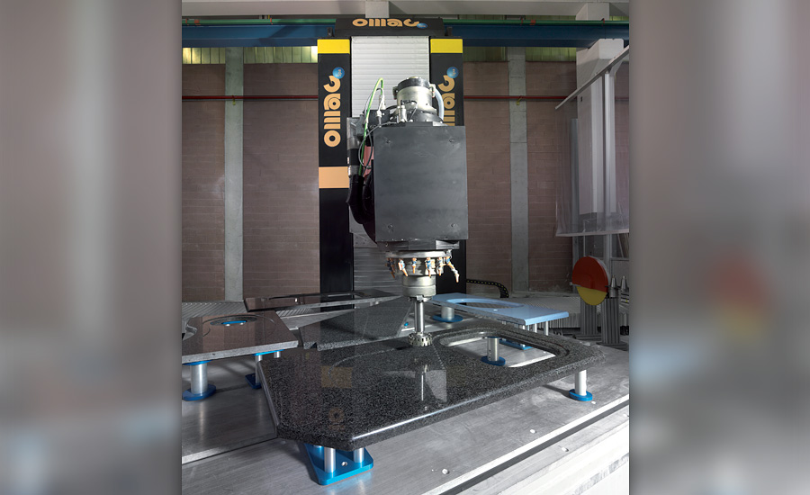 Countertop fabrication at the Living Stone workshop — a granite slab being cut and profiled to size